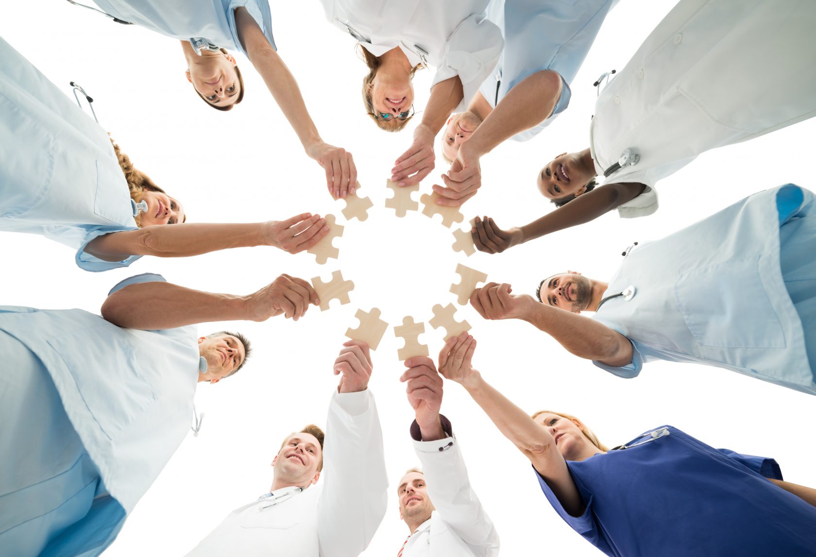 Medical Team Joining Jigsaw Pieces In Huddle